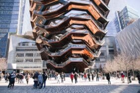 Pedestrians bustling near The Vessel at Hudson Yards, with its stunning view captivating visitors eager to see it up close