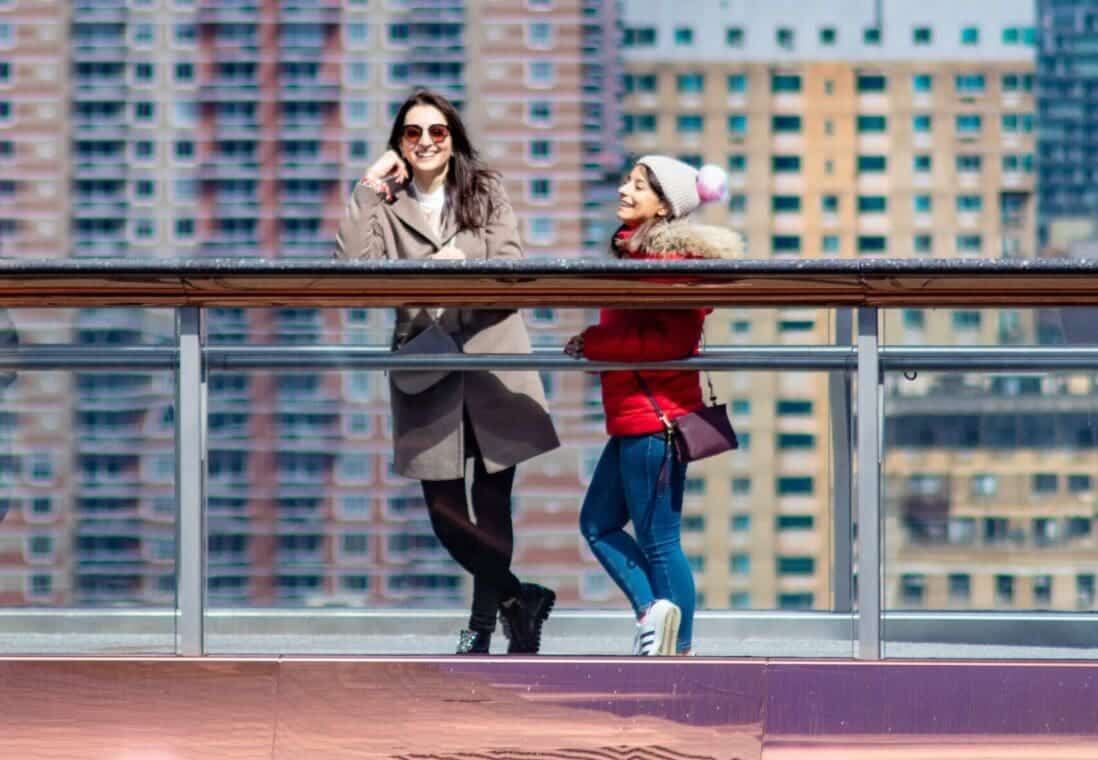A Woman and Her Child her standing on a balcony at Hudson Yards