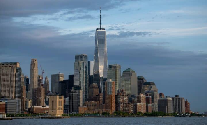 beautiful One World Trade Center seen from a distance, with the stunning view of New York City & the surrounding sea