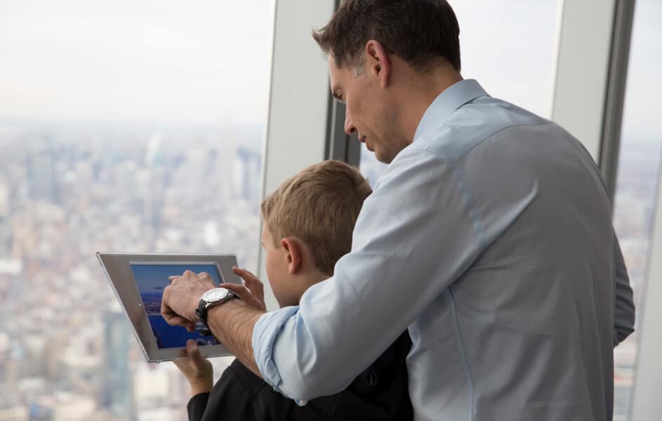 Father & son with the digital skyline guide at One World Observatory