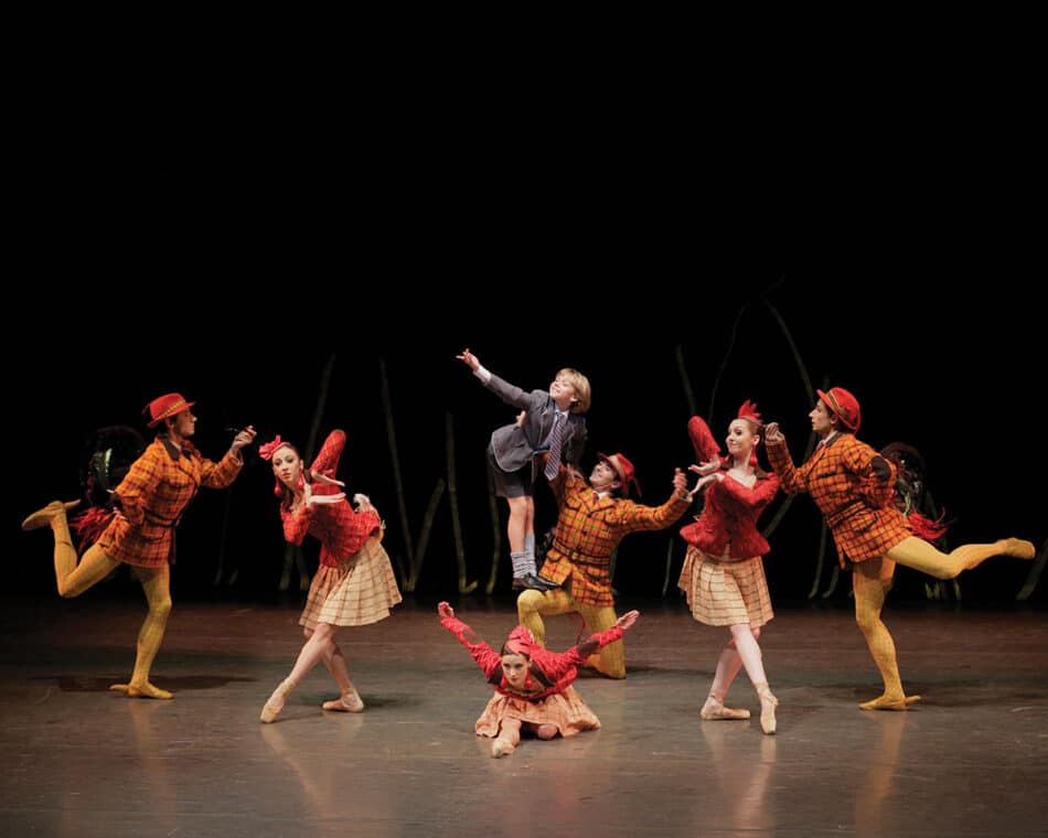 Three men, two women, and a young boy performing in a New York City Ballet theater show at Lincoln Center