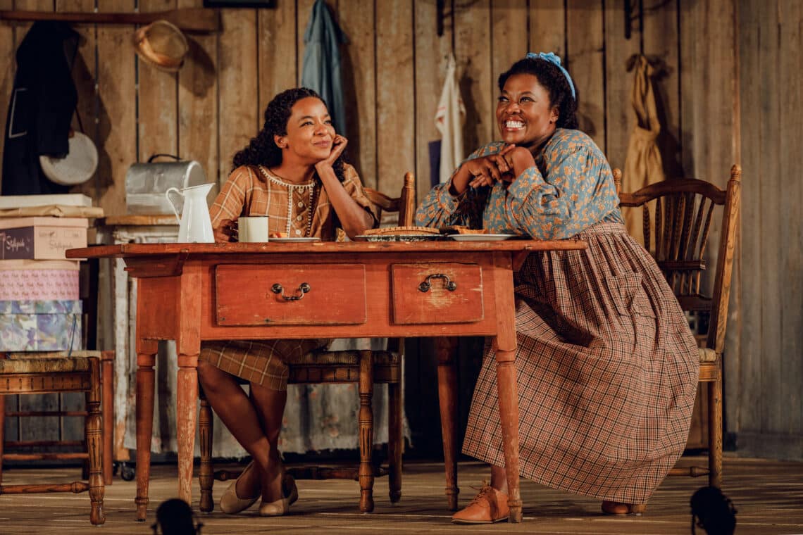 A young girl listens to her mother's story inside the Broadway musical 'Purlie Victorious'