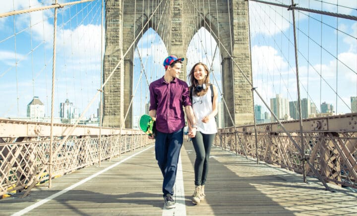 Young couple walking on the brooklyn bridge