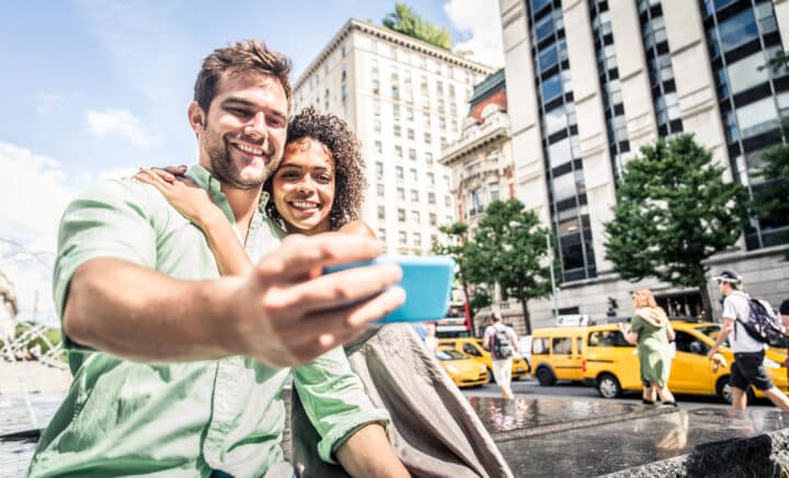 Couple of tourists taking a selfie in NYC