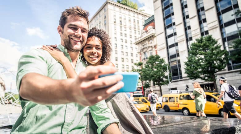 Couple of tourists taking a selfie in NYC