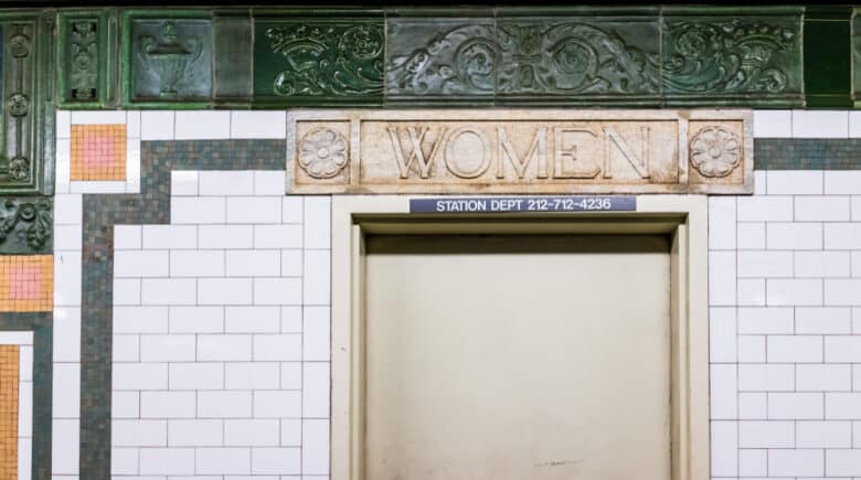Women sign in underground platform transit in NYC Subway Station