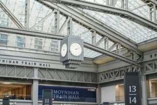 a clock in the middle of a train station