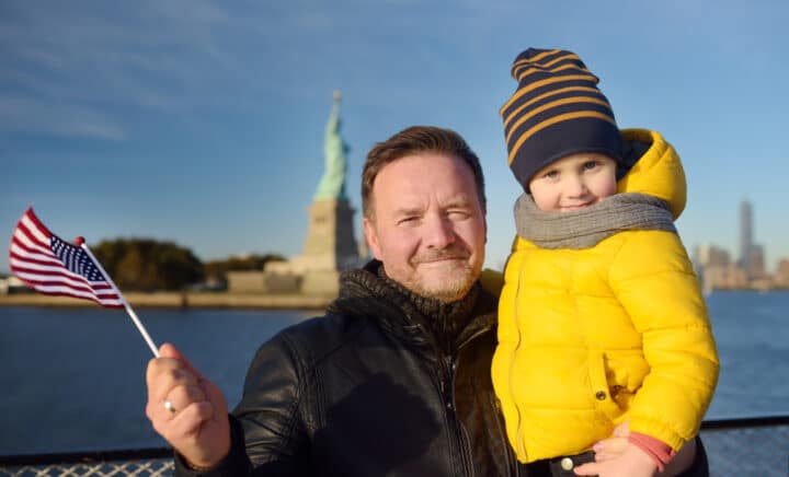 Father and his little son holding the American flag