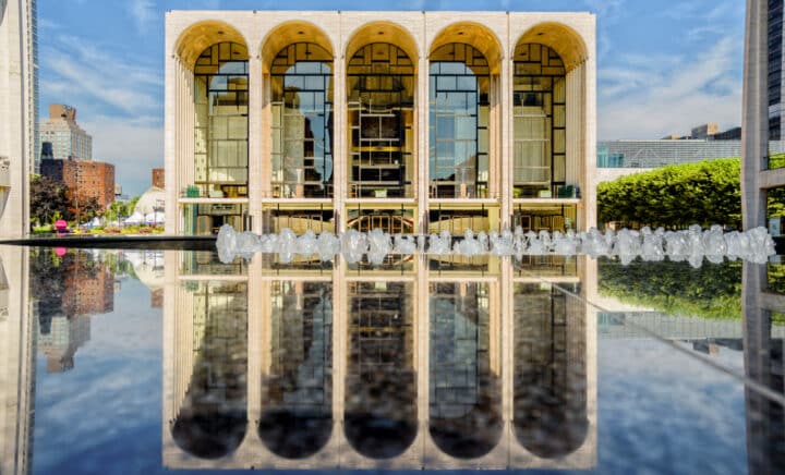 The Metropolitan Opera House reflected on the marble fountain of the Lincoln Square