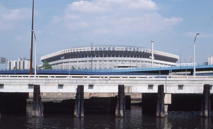 The majestic Yankee Stadium stands under a clear blue sky, a testament to the Bronx's sporting legacy.