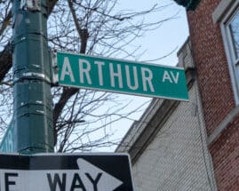 A closeup of New York City street sign for Arthur Avenue