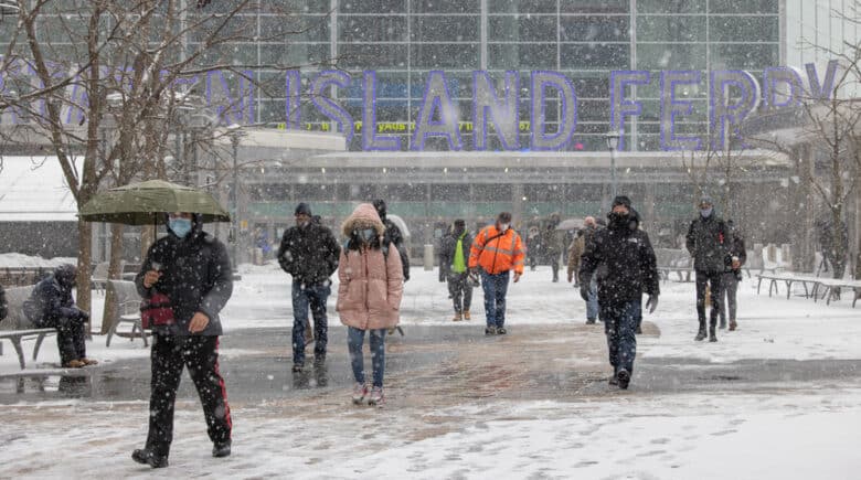 People near the Staten Island Ferry terminal during winter