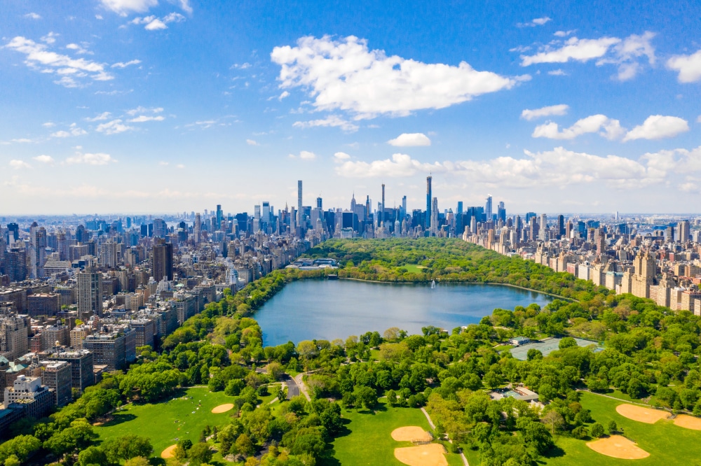 Aerial view of the Central park in New York with golf fields and tall skyscrapers surrounding the park.