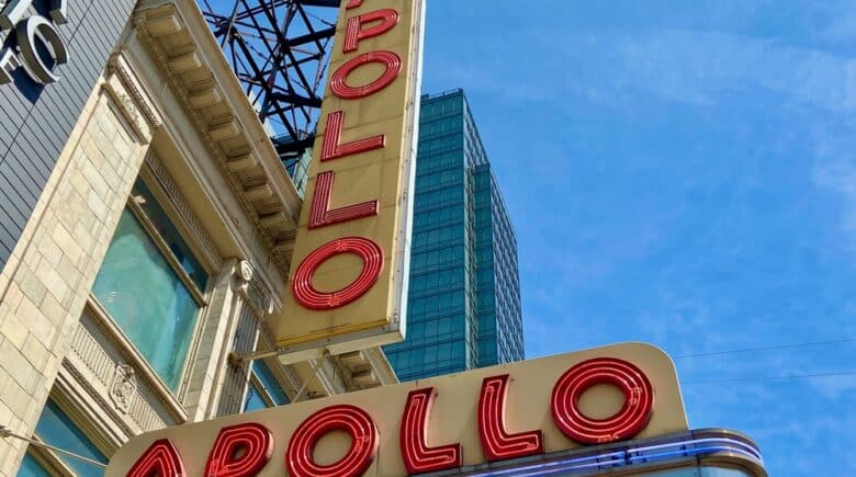 The red and yellow neon sign of the Apollo Theater in Harlem