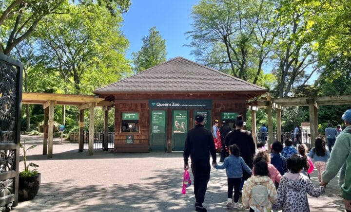 Queens, New York - May 25, 2023: View of the Queens Zoo in New York City seen at the entrance gate with visitors in view.