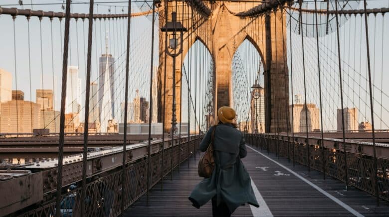 Tourist on Brooklyn Bridge in the Morning Light