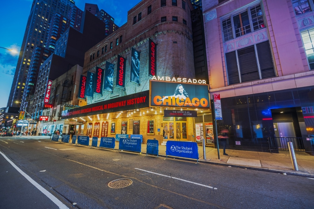 Night view of New York City with the Ambassador Theatre showcasing the 'Chicago' musical. New York. USA. 08.18.2024.