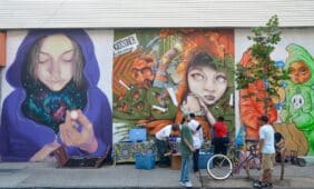 Three impressive mural artworks featuring a woman, a child, and a character at East Williamsburg in Brooklyn