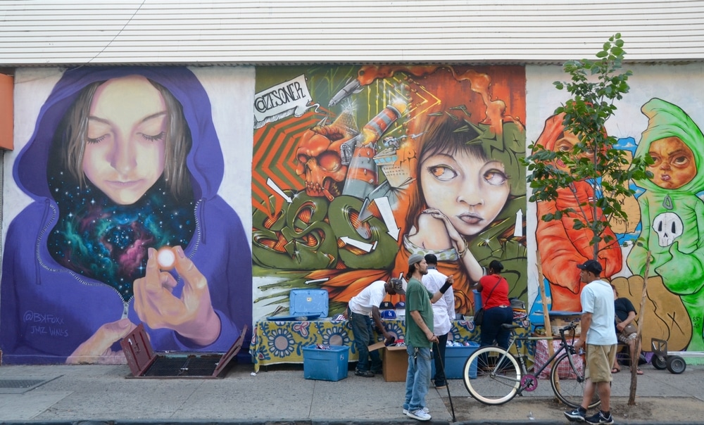 Three impressive mural artworks featuring a woman, a child, and a character at East Williamsburg in Brooklyn