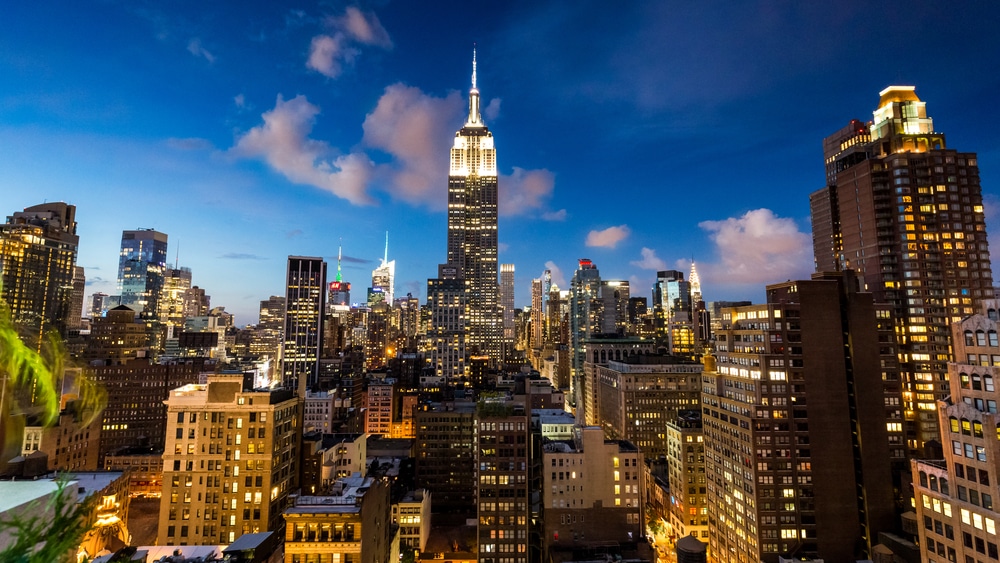 NEW YORK - AUGUST 23: View to Midtown Manhattan with the famous Empire State Building at sunset on August 23, 2015. This view is from the rooftop of the 230-fifth Bar.