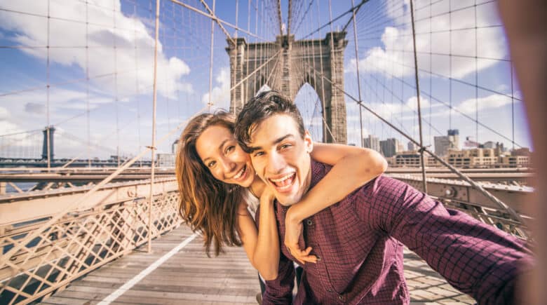 Couple taking selfie on Brooklyn Bridge