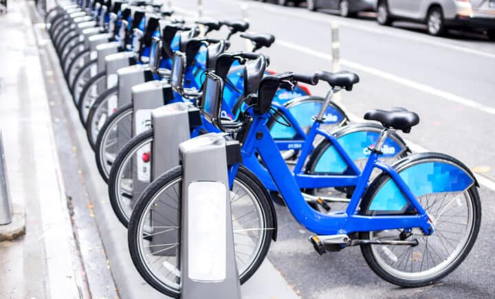 A row of rental bikes lined up on a street in NYC