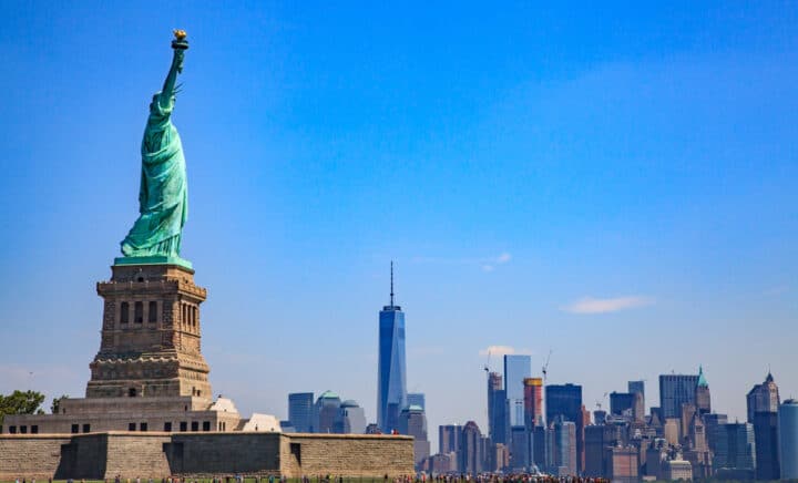 Statue of Liberty with the Lower Manhattan skyline in the background, showcasing one of the Top 10 NYC Must-See Attractions and highlighting iconic New York City activities and New York City must-see landmarks for visitors