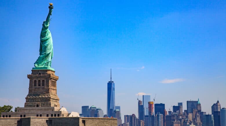 Statue of Liberty with the Lower Manhattan skyline in the background, showcasing one of the Top 10 NYC Must-See Attractions and highlighting iconic New York City activities and New York City must-see landmarks for visitors