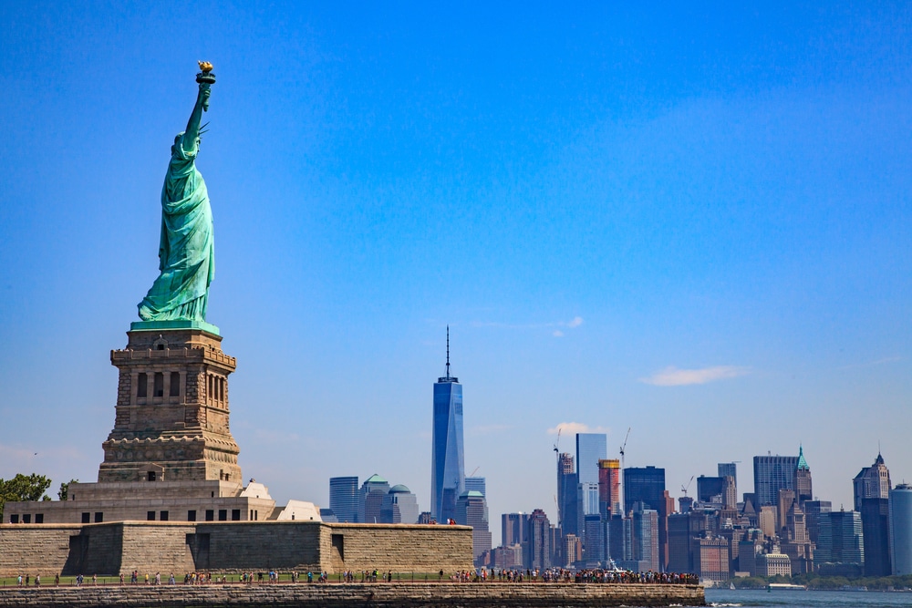 Statue of Liberty with the Lower Manhattan skyline in the background, showcasing one of the Top 10 NYC Must-See Attractions and highlighting iconic New York City activities and New York City must-see landmarks for visitors