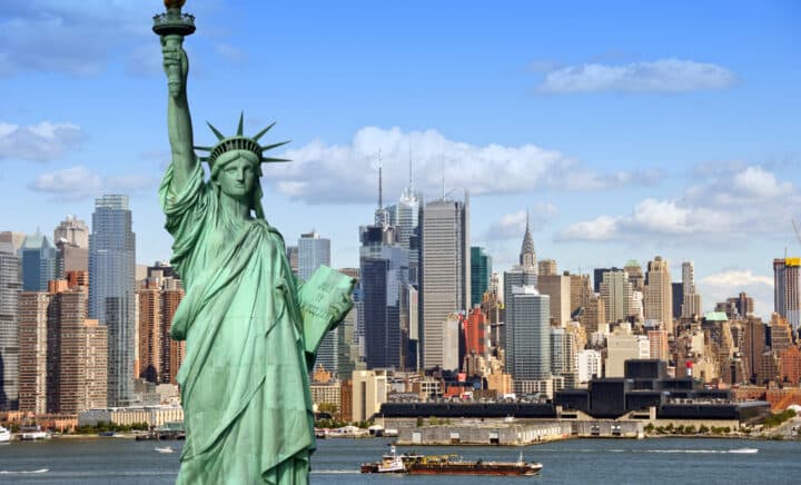 New York City skyline cityscape with Statue of Liberty over Hudson River