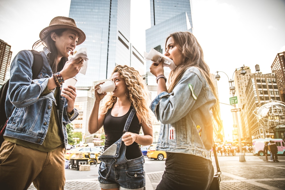 People enjoying NYC street foods in a tour