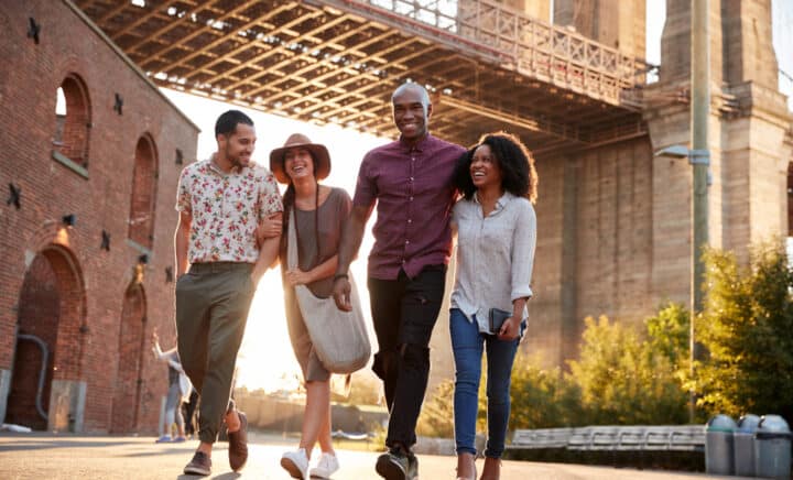 Friends Walking By Brooklyn Bridge