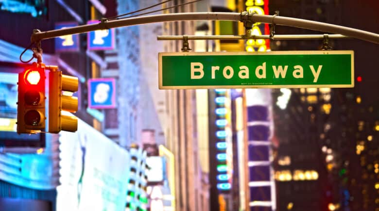 Broadway sign and red stop light in New York City