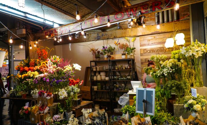 A flower shop filled with lots of different types of flowers in Chelsea Market