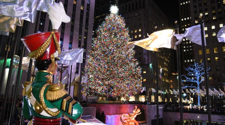 A Large toy nutcracker drummer statue and the holiday lights in Rockefeller Center