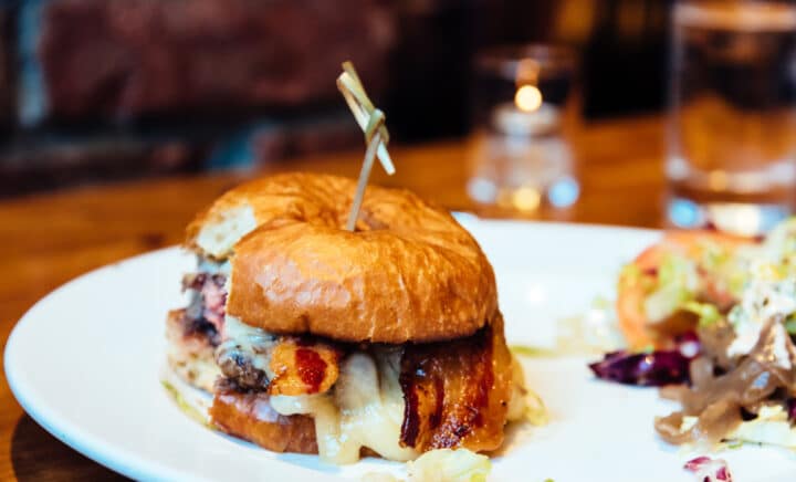 Close up of tasty bacon cheese burger on restaurant