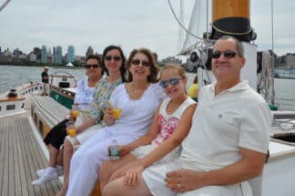 A family enjoying NYC cruise tour with drinks and food