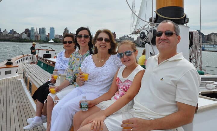 A family enjoying NYC cruise tour with drinks and food