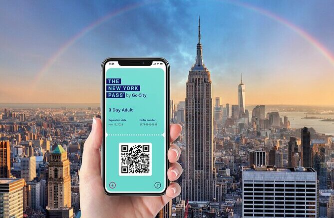 Hand holding a phone displaying the New York Pass with the Empire State Building and city skyline in the background