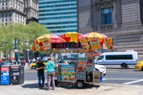 A hot dog vendor stationed near Battery Park in Lower Manhattan, serving up iconic New York City street food