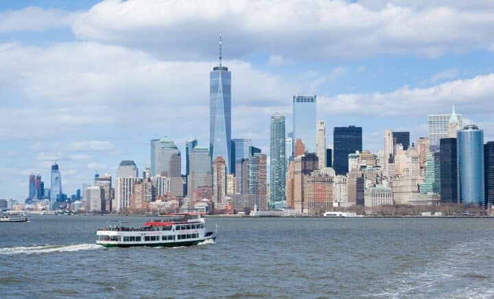 Ferry cruising on the river with the New York City skyline, including One World Trade Center, in the background