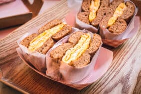 Freshly baked crunchy typical bagels with sesame, poppyseed topping and scrambled eggs from coffee shop or bakery in Manhattan