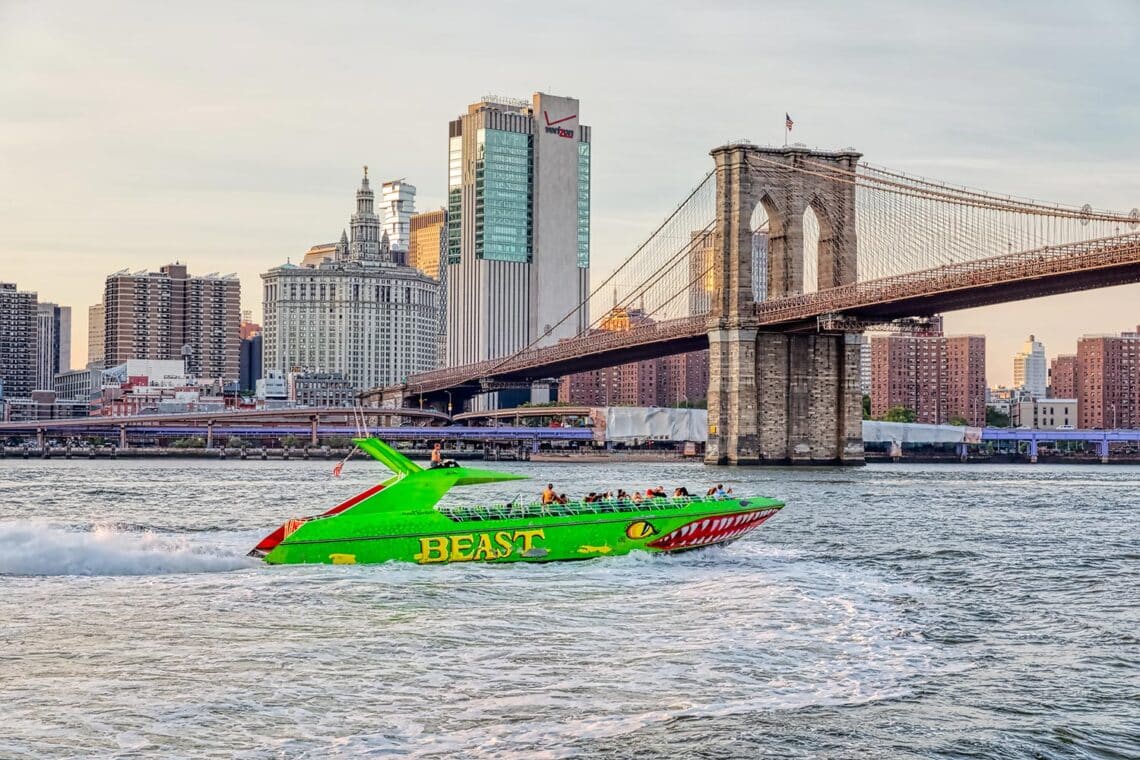 A green speedboat bearing the name 'Beast' will pass under the Brooklyn Bridge