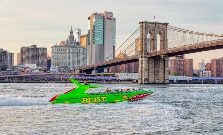 A green speedboat bearing the name 'Beast' will pass under the Brooklyn Bridge