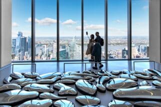 Interior view from an exhibition room with art installation and people taking selfie of Summit One Vanderbilt