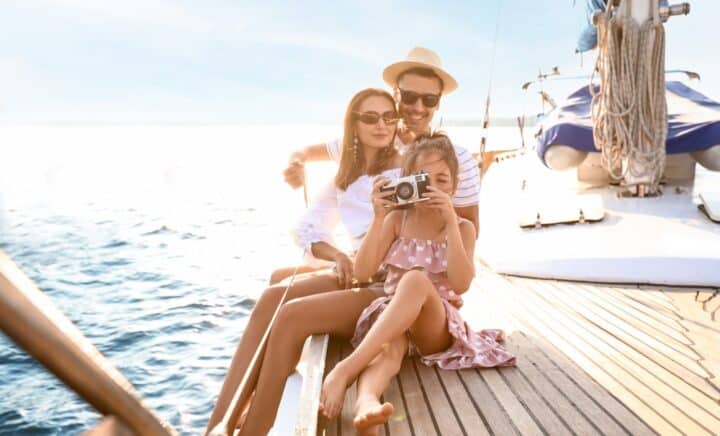 A kid with her mom and dad on a cruise boat