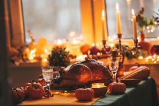 Thanksgiving day dinner with holiday autumn decor and candles