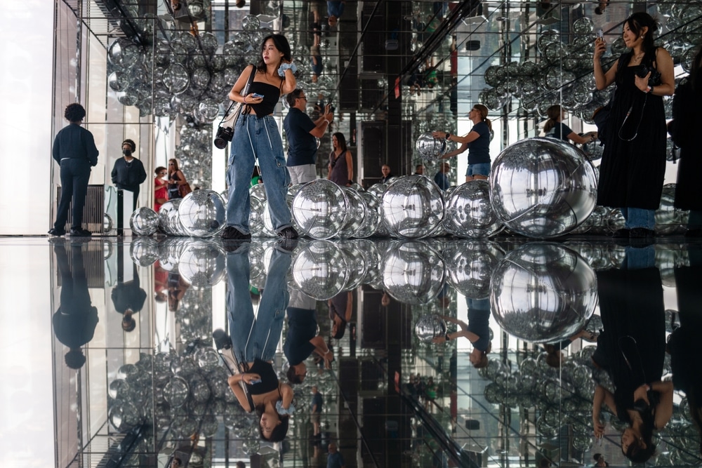 One Vanderbilt viewing exhibition, surrounded by artistic silver balloons and mirrored walls.