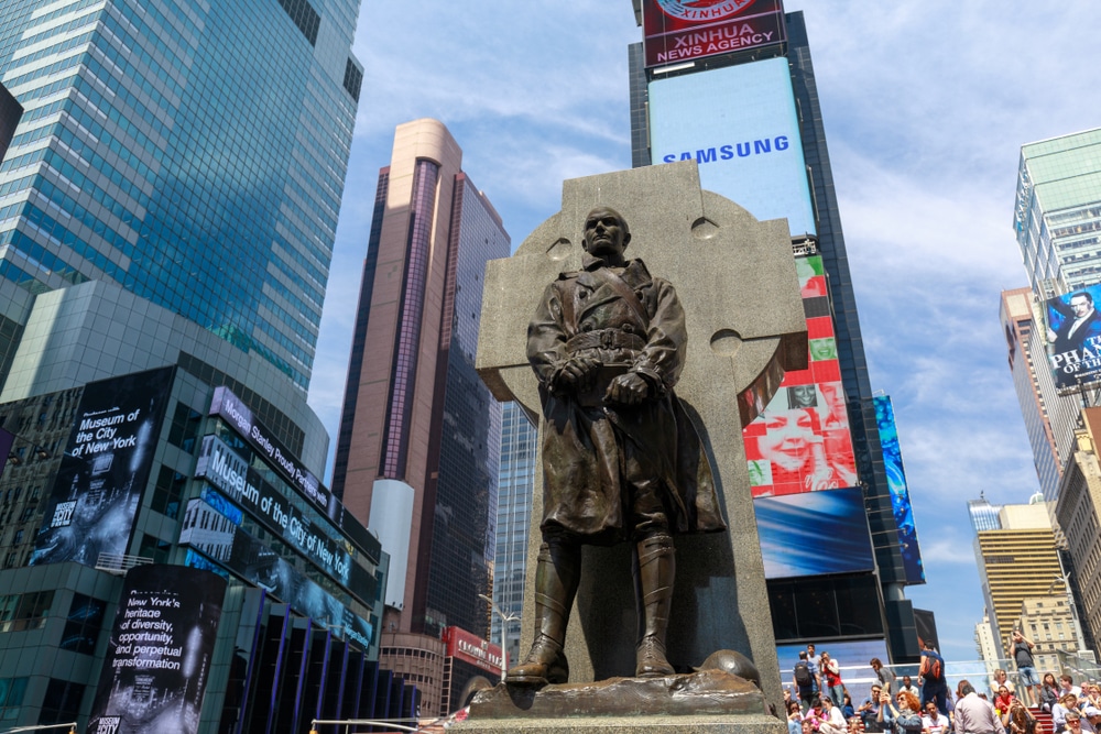 The statue of Father Duffy with street signs in Times Square, New York City