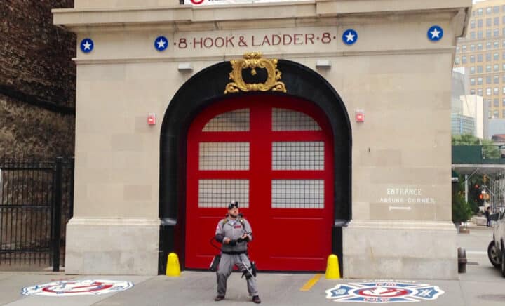 A man dressed as a Ghostbuster poses outside the Hook & Ladder 8 firehouse building where the popular movie was filmed in Tribeca, Manhattan